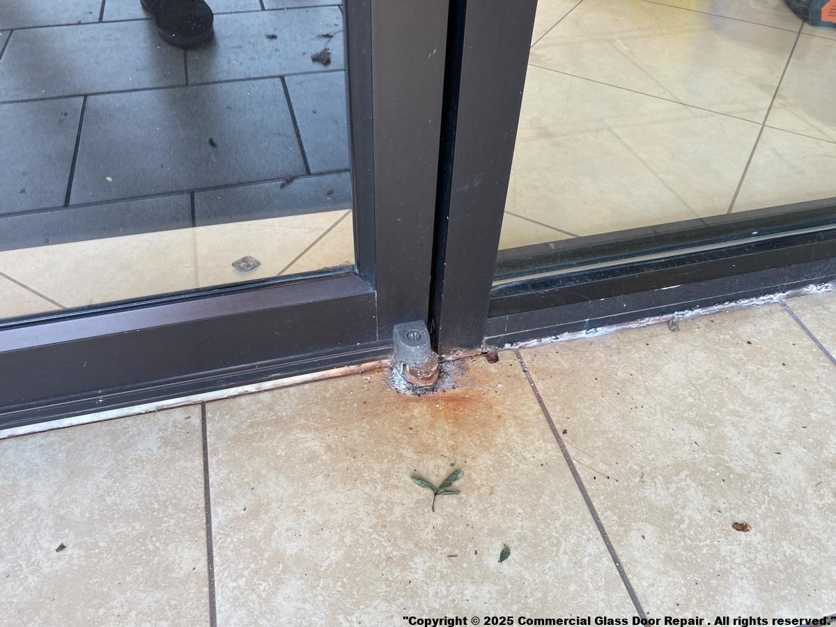 Engineer repairing automatic sliding door in London office building