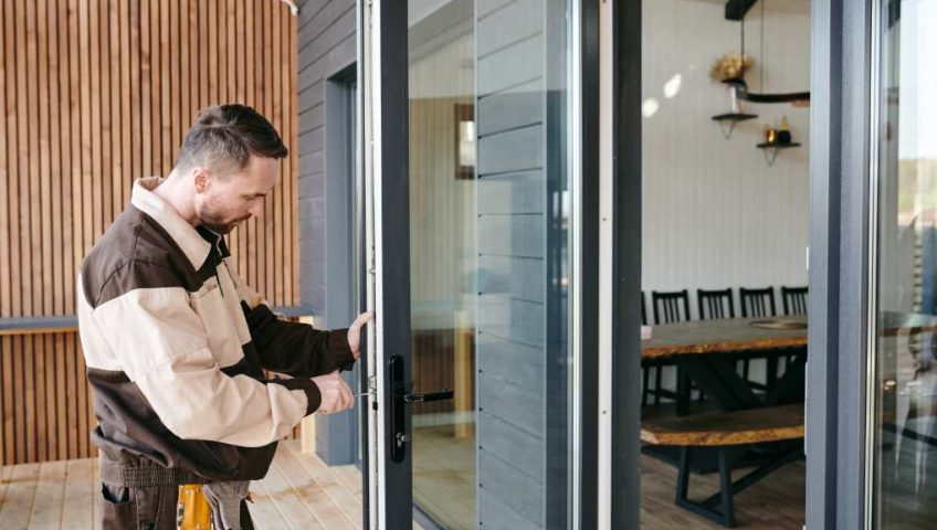 Commercial door engineer carrying out repair and safety checks in London